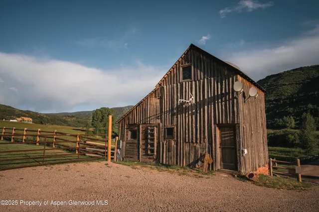 a front view of a house with a yard table and chairs