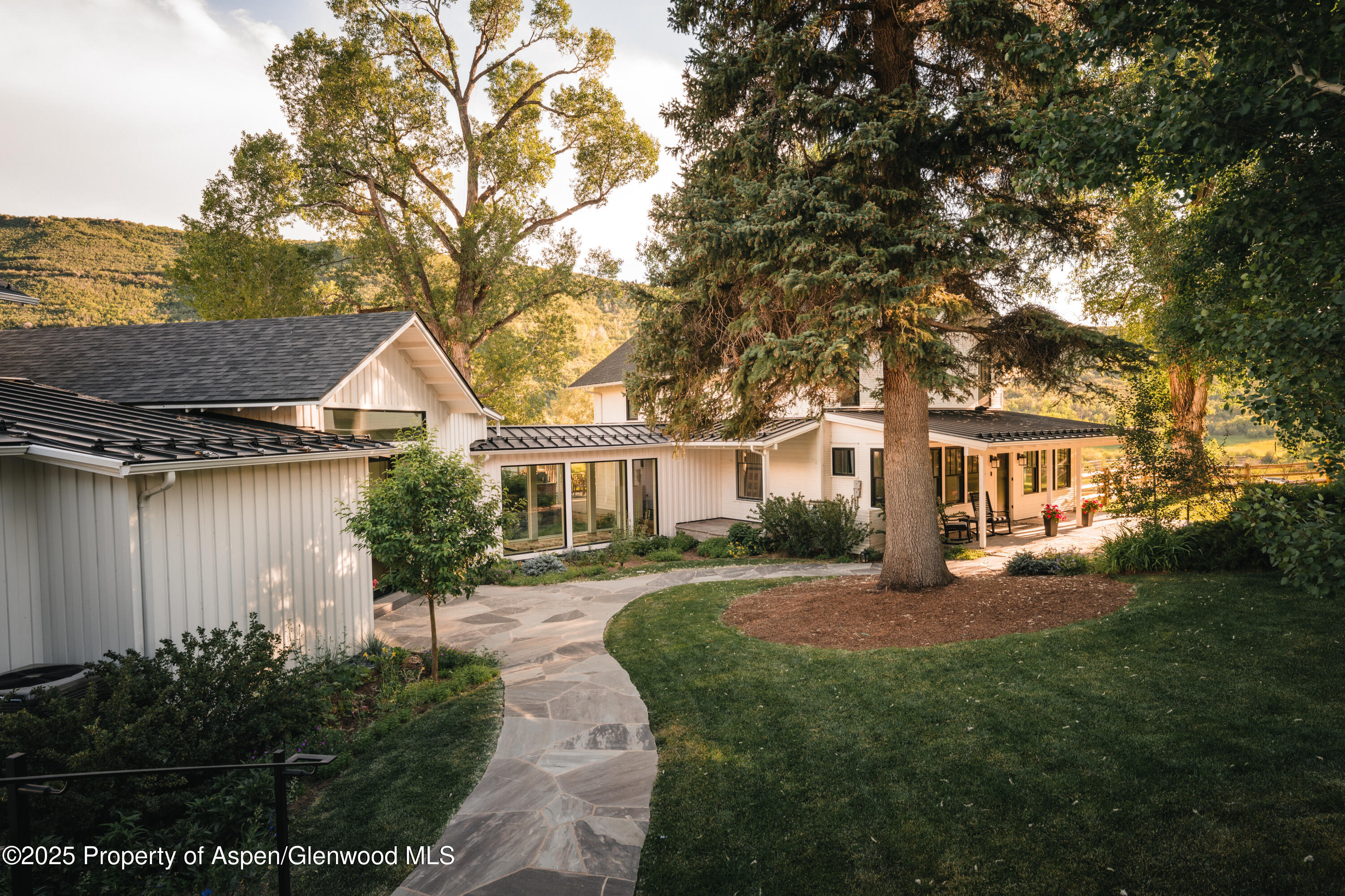 1814 Woody Creek Road Aspen, CO 81612 - Photo 9 of 52 a front view of a house with a garden