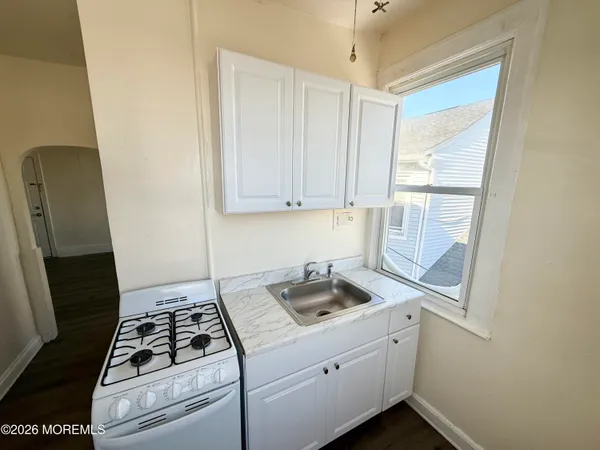a kitchen with sink and cabinets