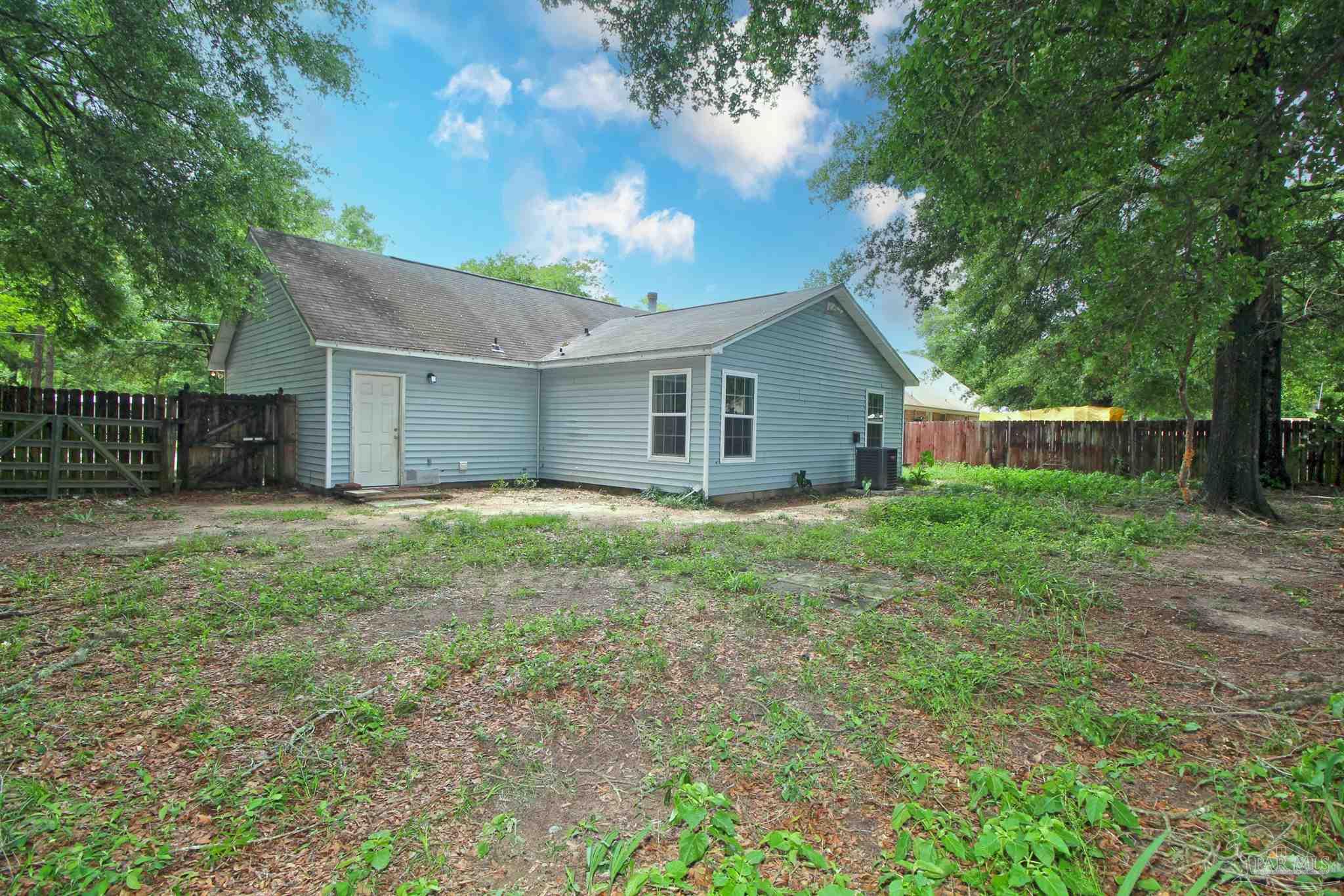 6528 Hunter Street Milton, FL 32570 - Photo 17 of 17 a view of a house with yard and a garden