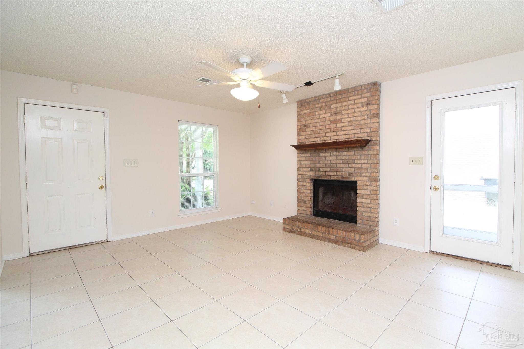 6528 Hunter Street Milton, FL 32570 - Photo 2 of 17 a view of a livingroom with a fireplace and window