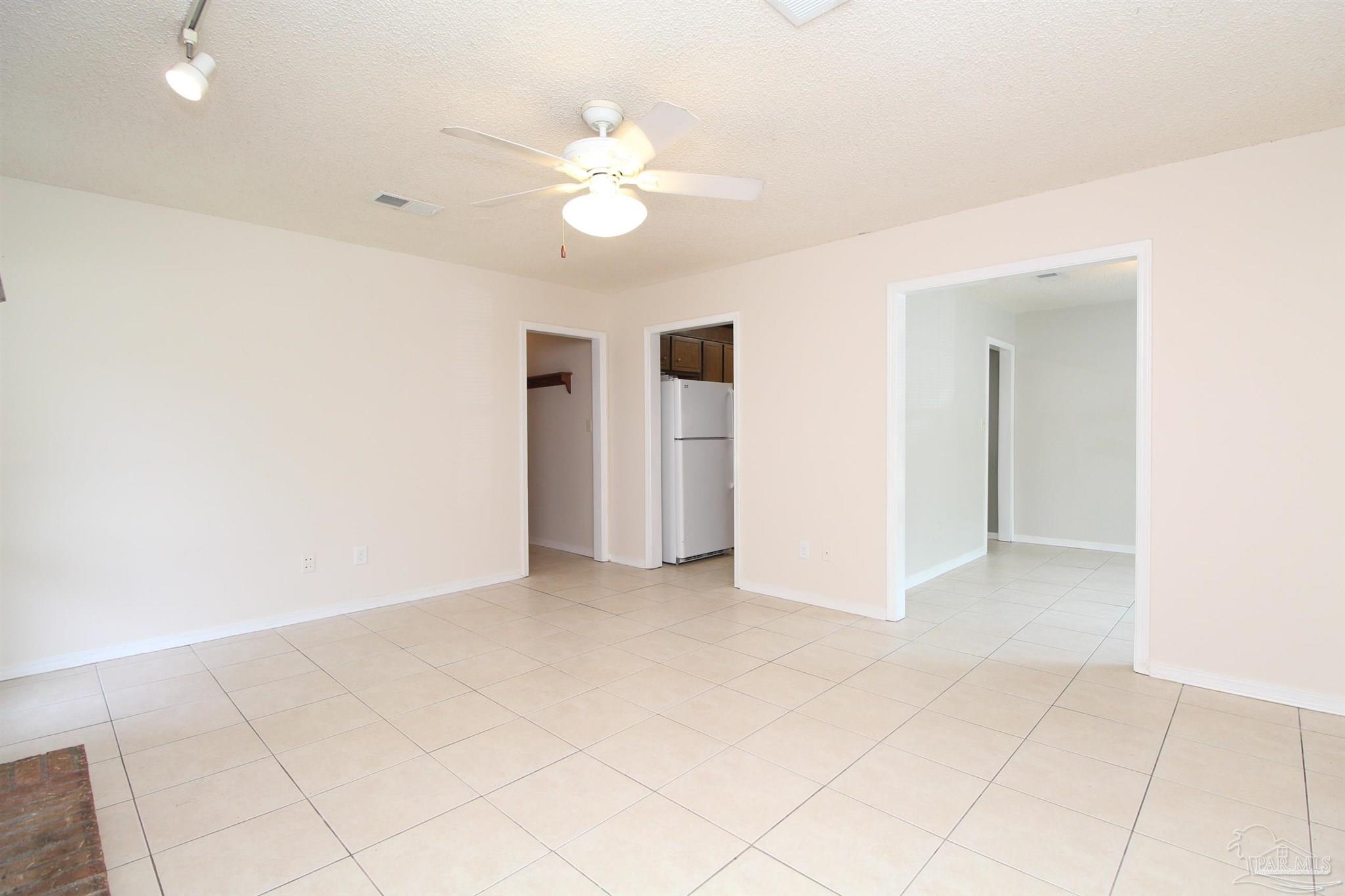 6528 Hunter Street Milton, FL 32570 - Photo 3 of 17 an empty room with fan and entrance