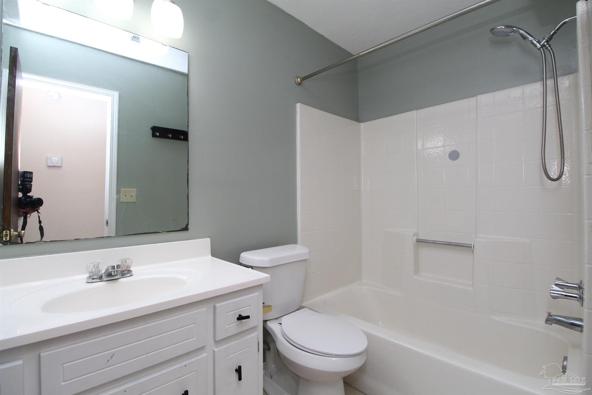 6528 Hunter Street Milton, FL 32570 - Photo 10 of 17 a bathroom with a sink toilet vanity and shower