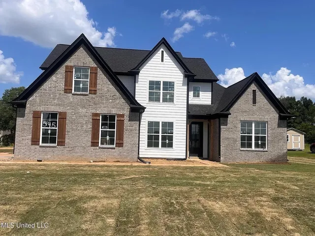 a front view of a house with glass windows