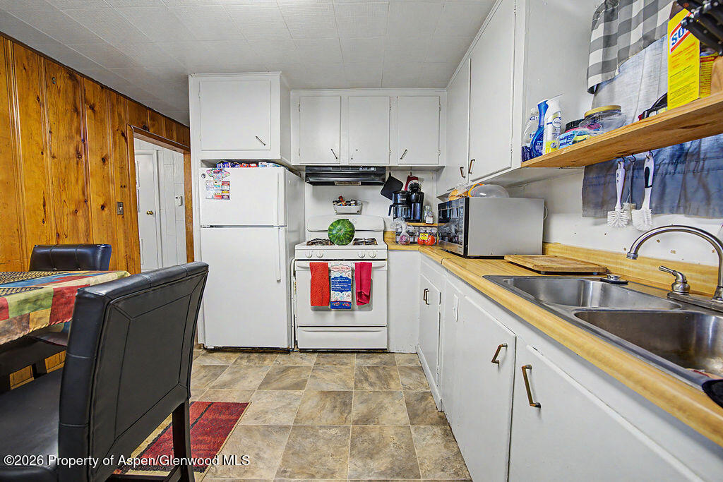 625 Russell Street Craig, CO 81625 - Photo 22 of 35 a kitchen with stainless steel appliances granite countertop a refrigerator a stove and a sink