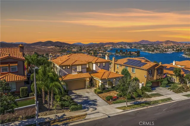 an aerial view of residential houses with an outdoor space and seating