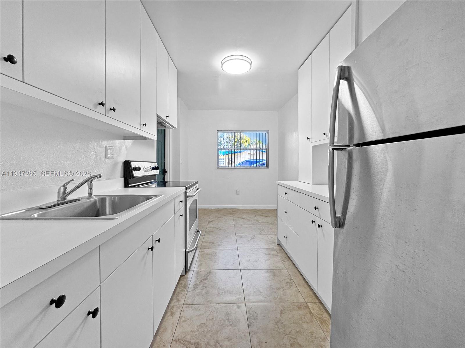 883 Southwest 10th Street, Unit 1 Pompano Beach, FL 33060 - Photo 11 of 20 a bathroom with a double vanity sink and mirror