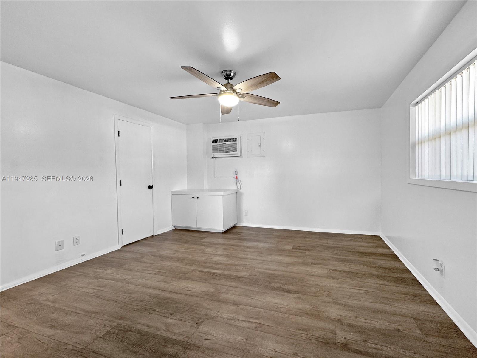 883 Southwest 10th Street, Unit 1 Pompano Beach, FL 33060 - Photo 12 of 20 a view of an empty room with a window