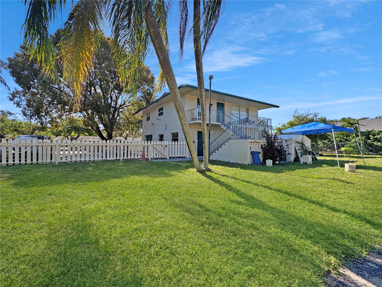 883 Southwest 10th Street, Unit 1 Pompano Beach, FL 33060 - Photo 15 of 20 a front view of a house with garden