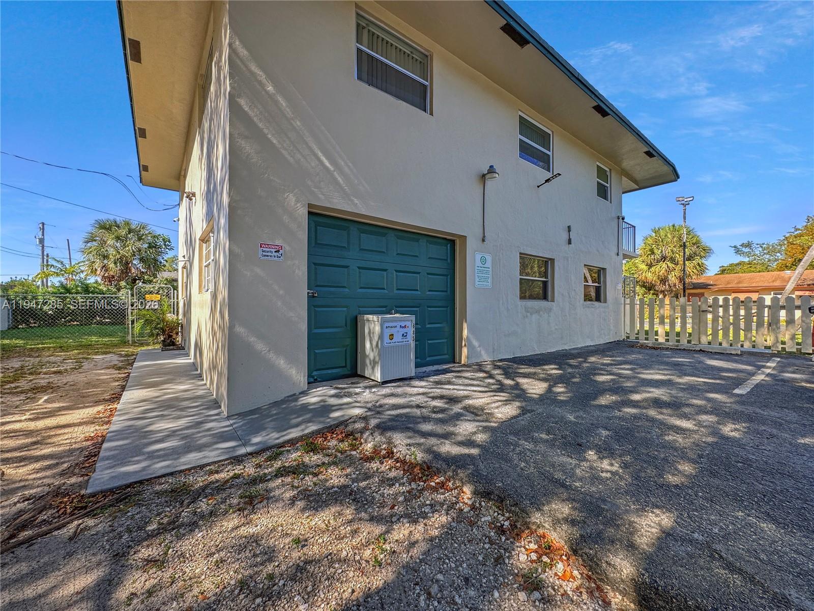 883 Southwest 10th Street, Unit 1 Pompano Beach, FL 33060 - Photo 17 of 20 a view of a house with a yard