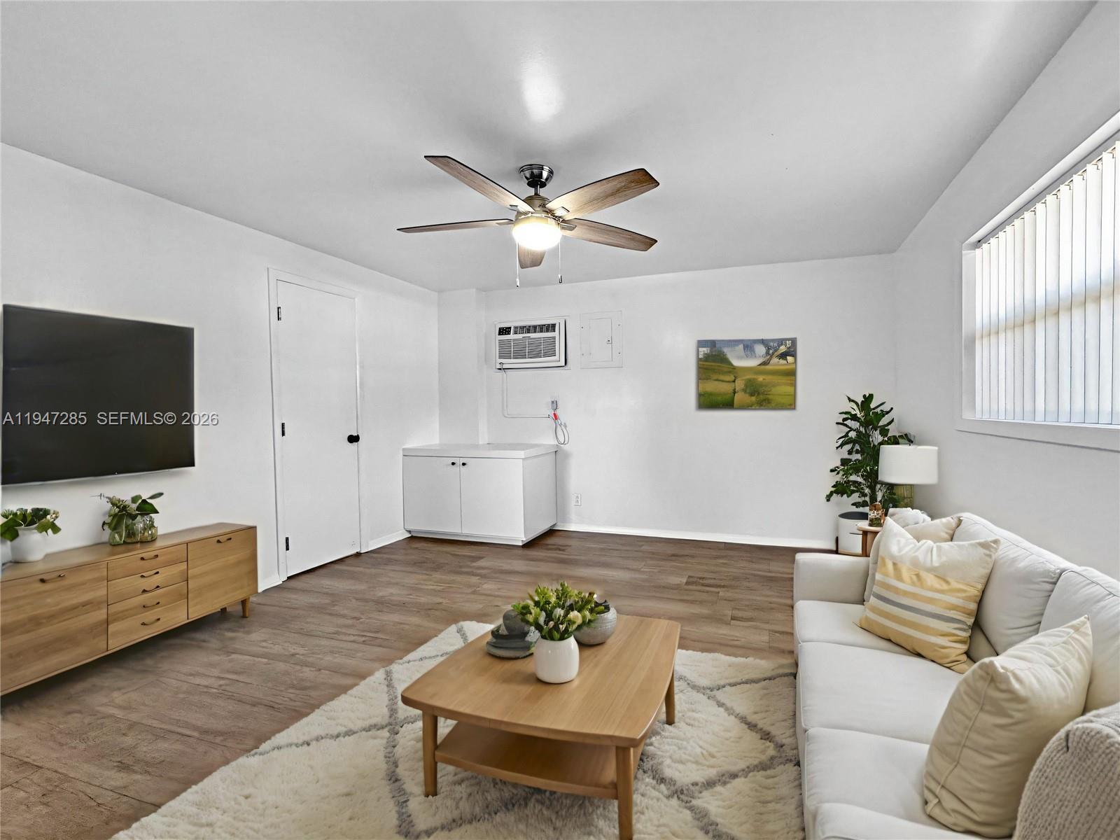 883 Southwest 10th Street, Unit 1 Pompano Beach, FL 33060 - Photo 3 of 20 a living room with furniture and a flat screen tv
