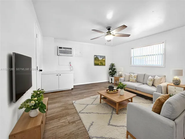 a living room with furniture potted plant and a window