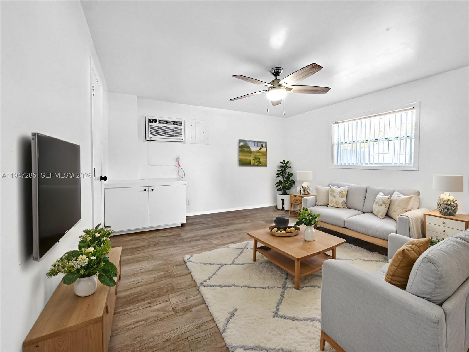 883 Southwest 10th Street, Unit 1 Pompano Beach, FL 33060 - Photo 4 of 20 a living room with furniture potted plant and a window