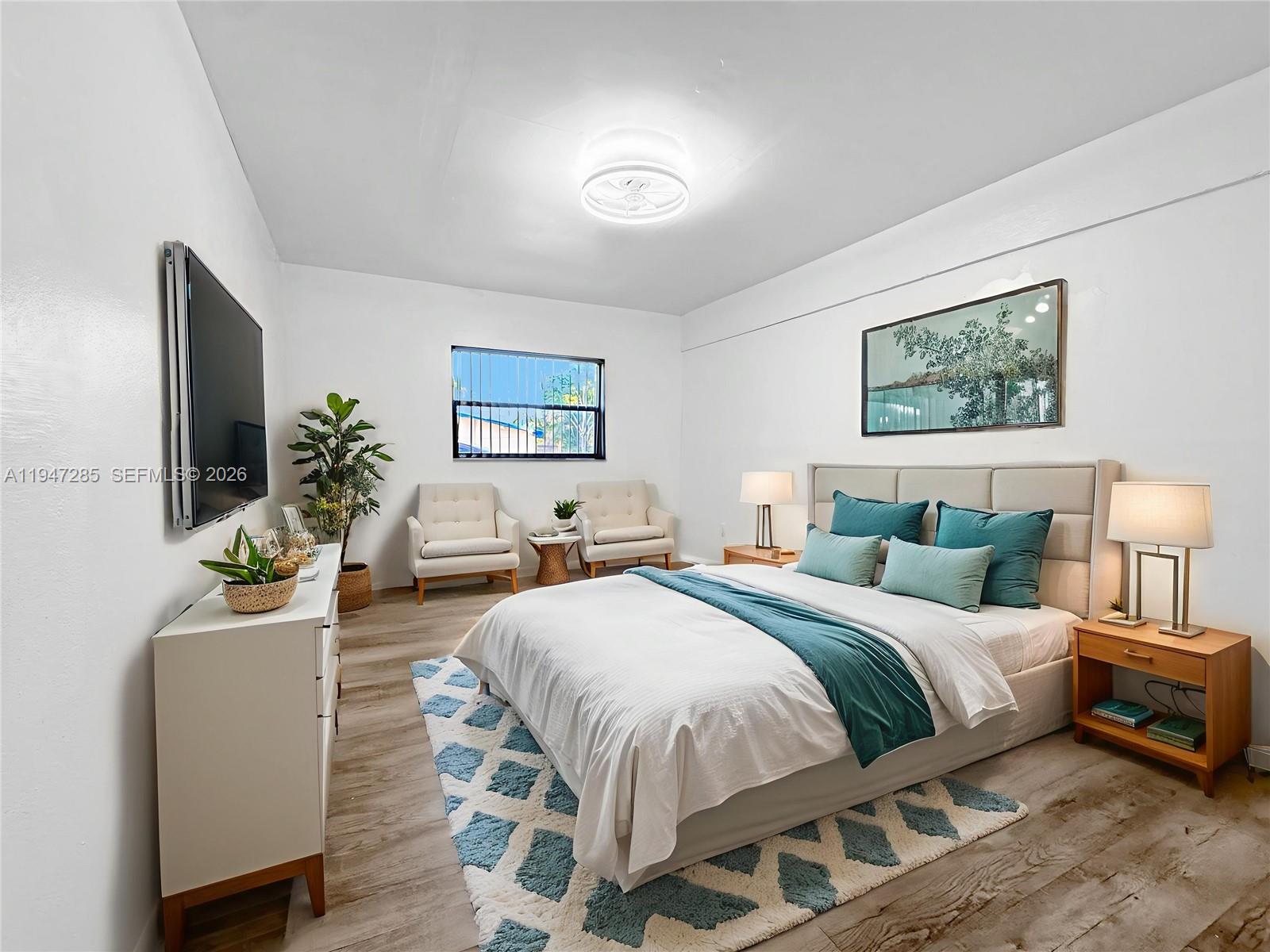 883 Southwest 10th Street, Unit 1 Pompano Beach, FL 33060 - Photo 5 of 20 a bedroom with a bed and a couch