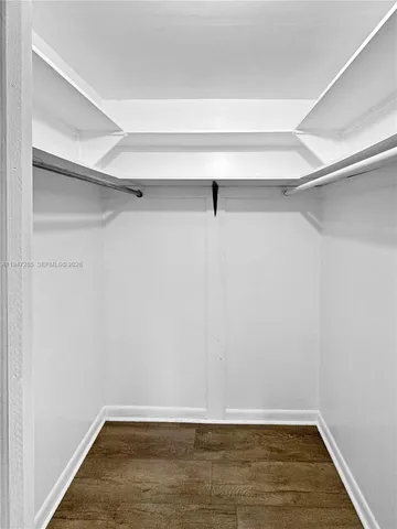 a view of a room with wooden floor