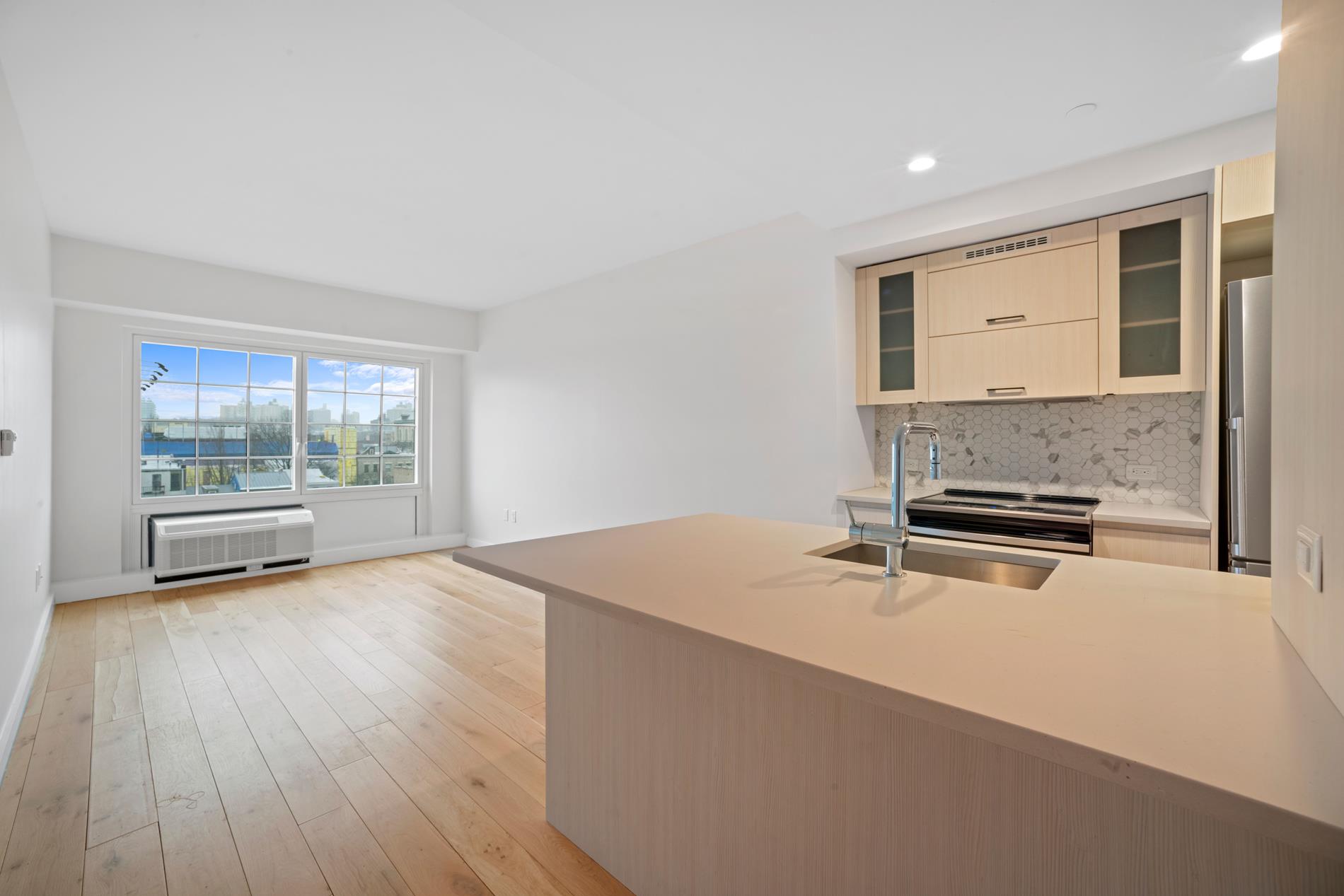 a kitchen with a stove a sink and a window