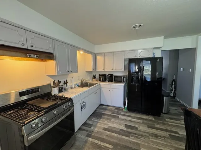 a kitchen with a stove and a refrigerator