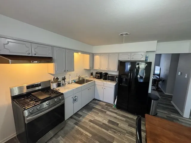 a kitchen with a stove and a refrigerator