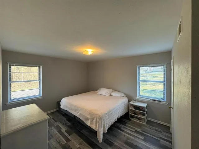 a bed sitting in a bedroom next to a window