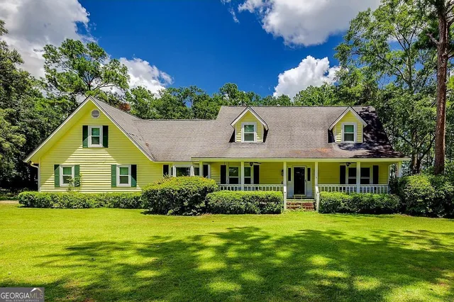 a front view of a house with a garden