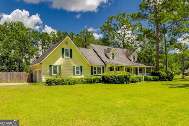 a front view of house with yard and green space