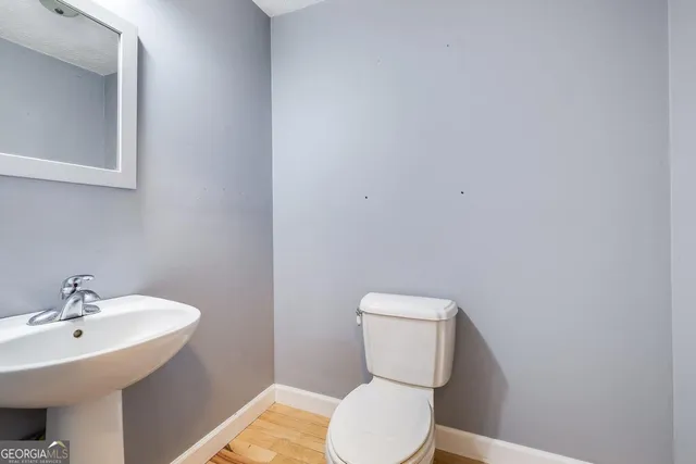 a white toilet sitting next to a bathroom sink