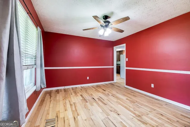 a view of a livingroom with a ceiling fan and window