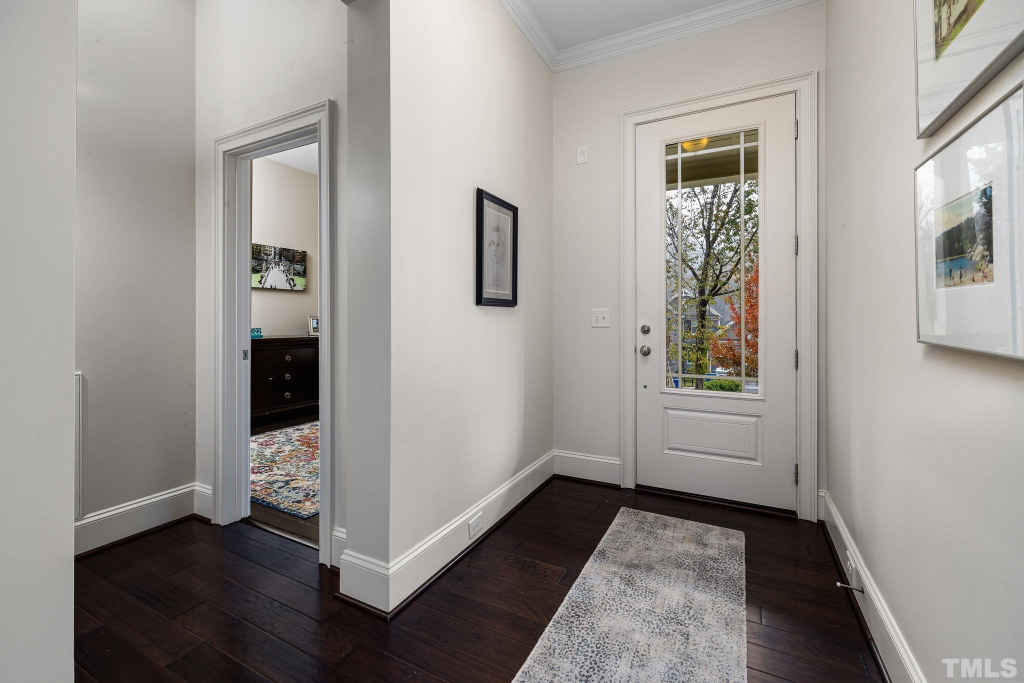 4526 Farrington Road Durham, NC 27707 - Photo 5 of 42 a view of hallway with window and wooden floor