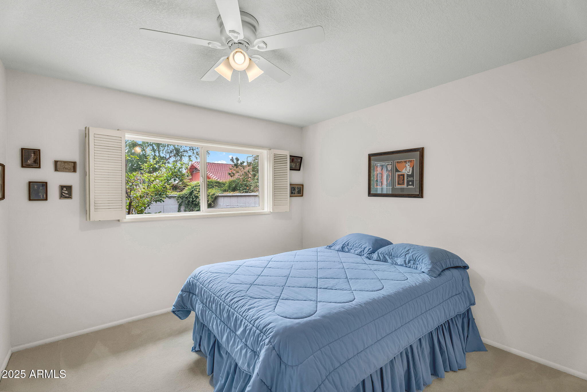 1515 West Palmaire Avenue Phoenix, AZ 85021 - Photo 16 of 23 a bedroom with a bed and a painting on the wall