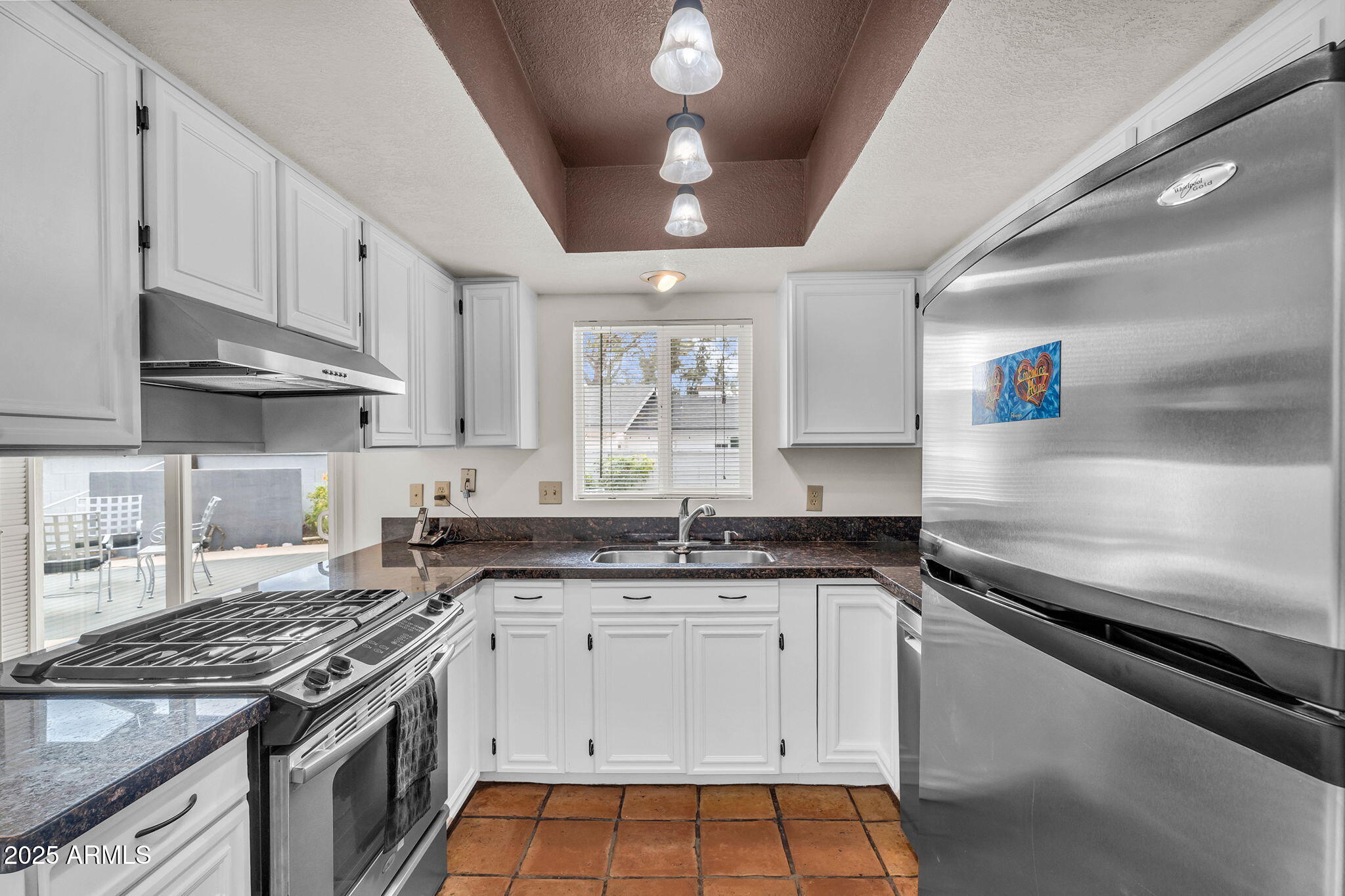 1515 West Palmaire Avenue Phoenix, AZ 85021 - Photo 9 of 23 a kitchen with granite countertop a stove sink and cabinets