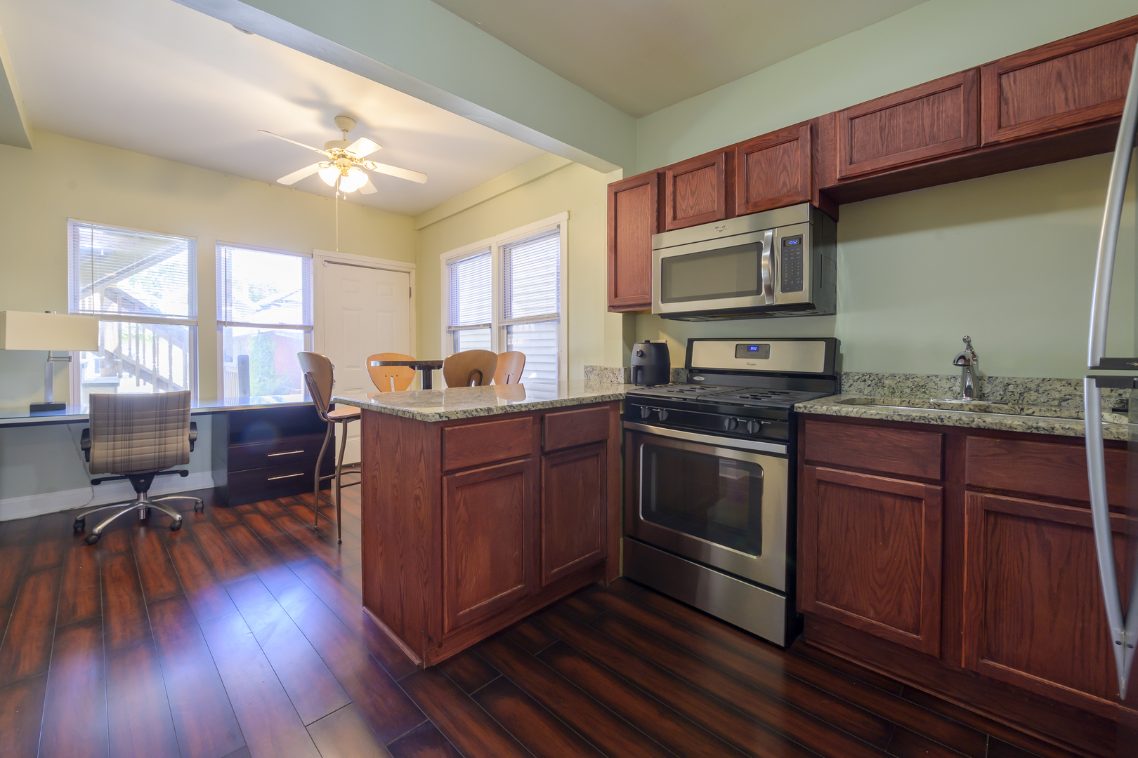 2436 West Fillmore Street Chicago, IL 60612 - Photo 12 of 44 a kitchen with granite countertop wooden floors appliances and cabinets