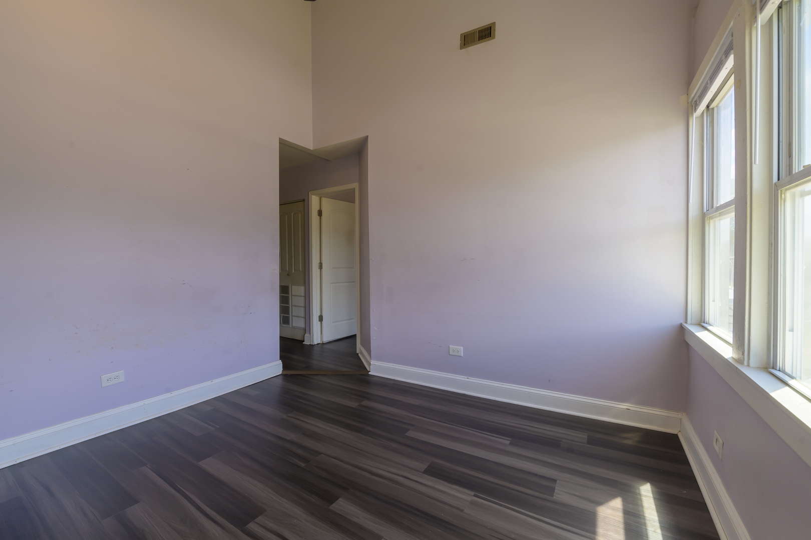 2436 West Fillmore Street Chicago, IL 60612 - Photo 21 of 44 a view of an empty room with wooden floor and a window
