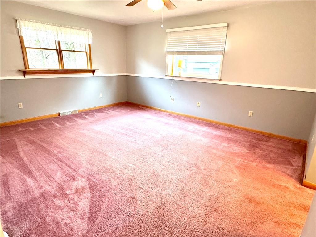 569 Whitestown Road Butler, PA 16001 - Photo 16 of 47 an empty room with wooden floor and windows