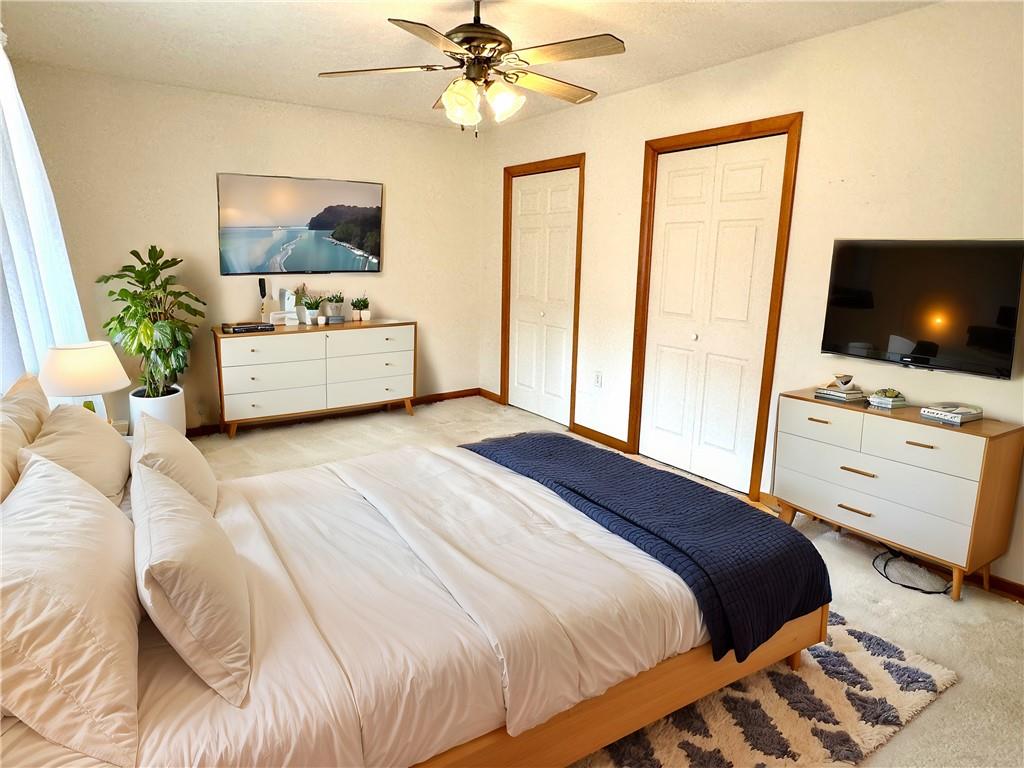 569 Whitestown Road Butler, PA 16001 - Photo 20 of 47 a bedroom with a bed a flat screen tv and a chandelier