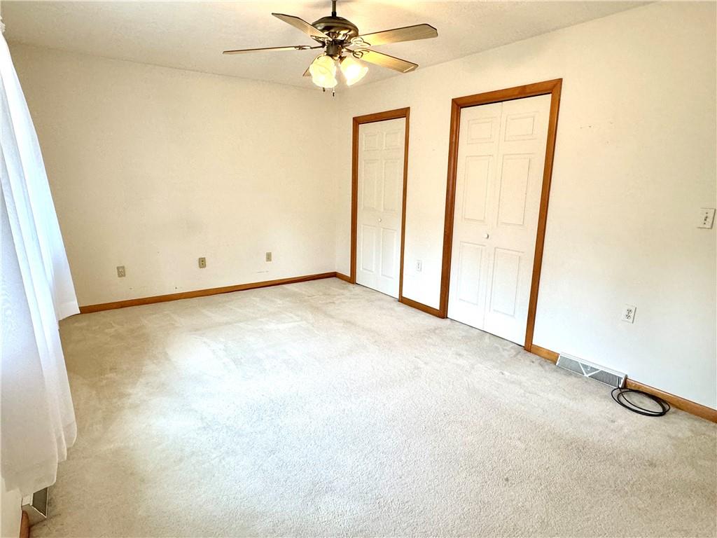 569 Whitestown Road Butler, PA 16001 - Photo 21 of 47 an empty room with a chandelier fan and a window