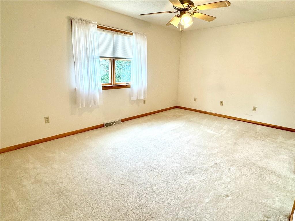 569 Whitestown Road Butler, PA 16001 - Photo 22 of 47 an empty room with a ceiling fan and a window