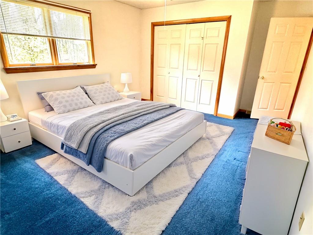 569 Whitestown Road Butler, PA 16001 - Photo 23 of 47 a bedroom with a bed and wooden floor