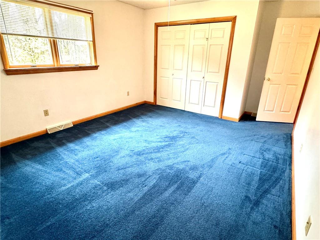 569 Whitestown Road Butler, PA 16001 - Photo 24 of 47 an empty room with wooden floor and windows
