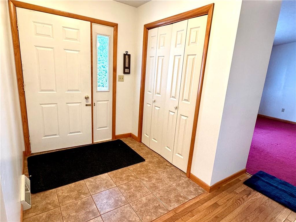 569 Whitestown Road Butler, PA 16001 - Photo 5 of 47 a view of a hallway with wooden floor and a cabinet