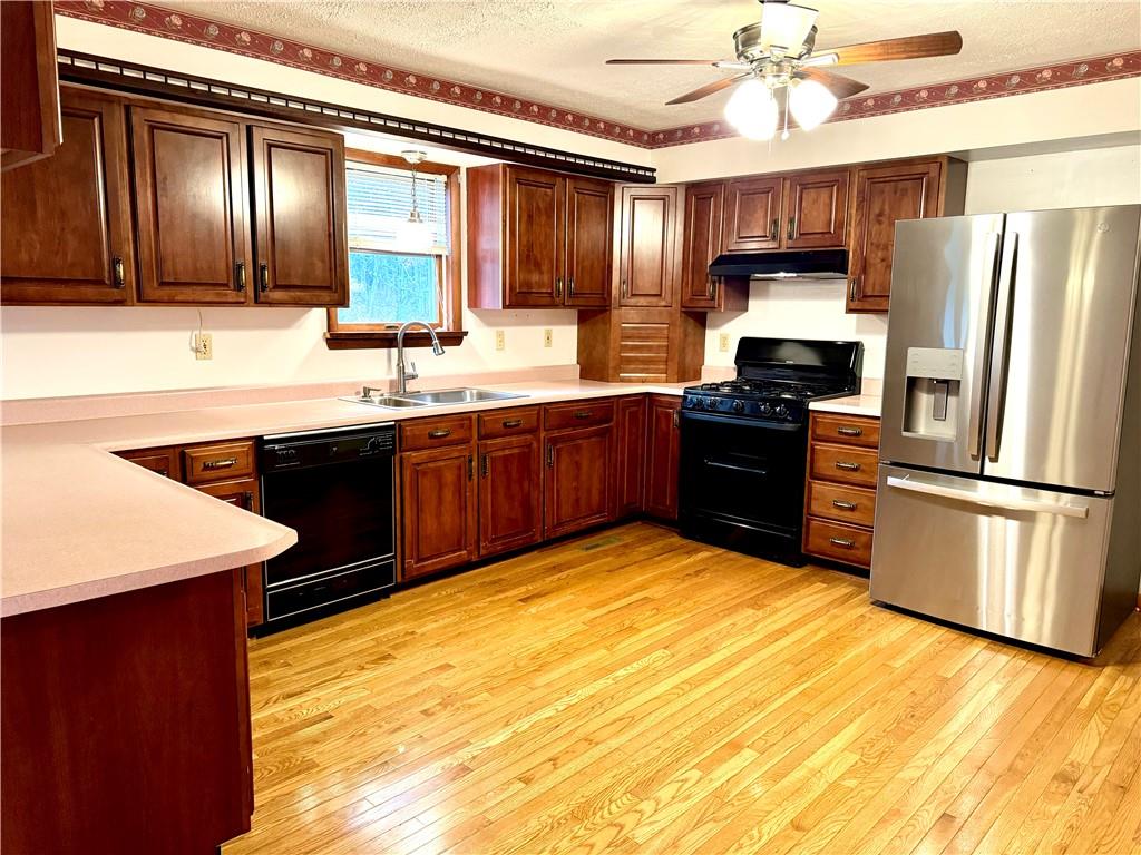 569 Whitestown Road Butler, PA 16001 - Photo 6 of 47 a kitchen with stainless steel appliances granite countertop a stove refrigerator sink and microwave