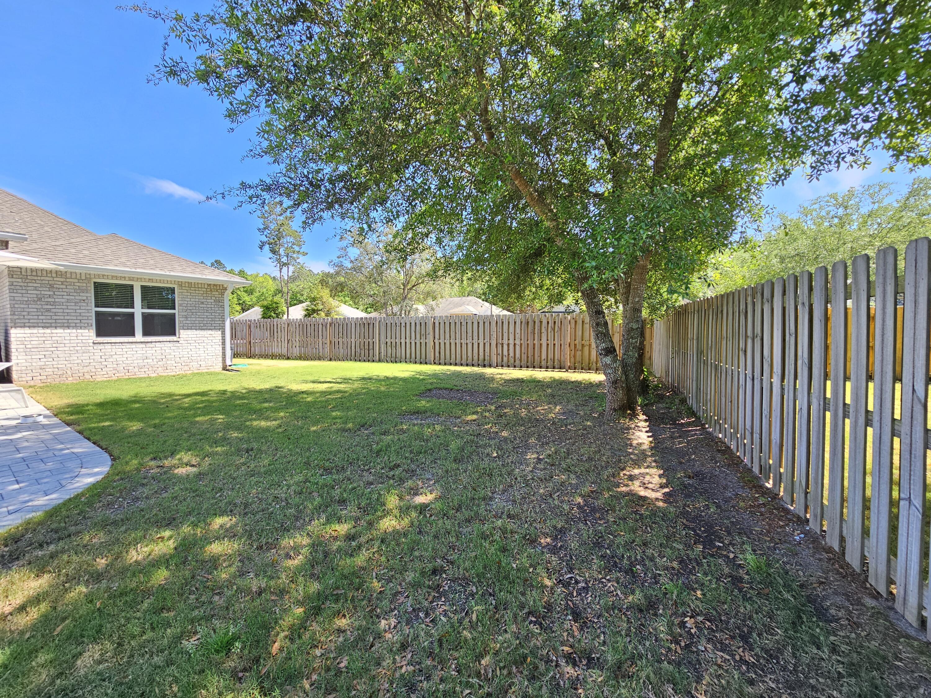 137 Autumn Avenue Freeport, FL 32439 - Photo 44 of 57 a view of a backyard with a small cabin