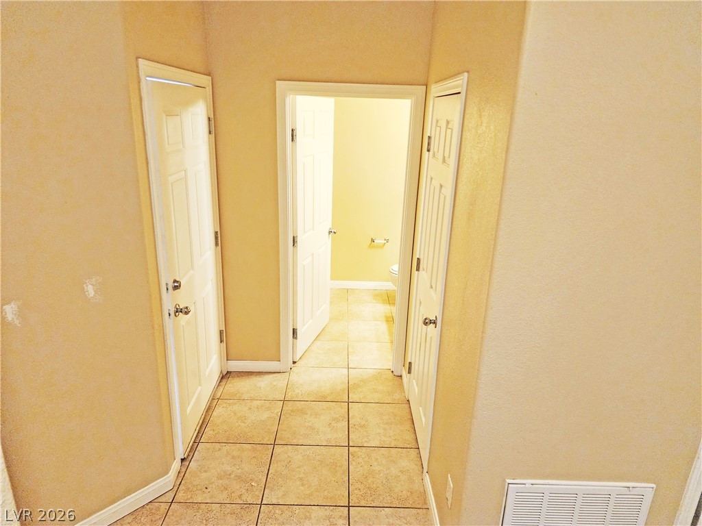 1421 Star Road, Unit 2 Pahrump, NV 89048 - Photo 15 of 33 Hallway with visible vents, baseboards, and light tile patterned flooring