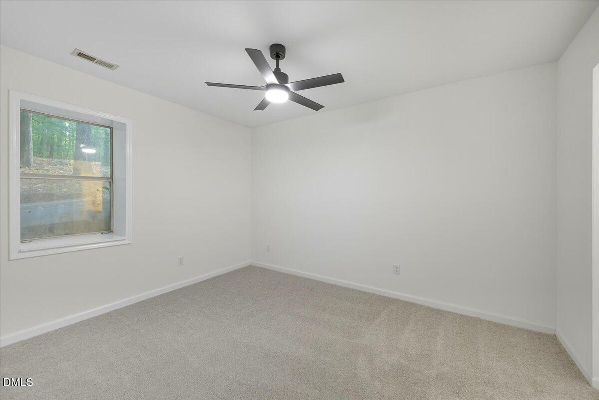 102 Choptank Court, Unit A2 Cary, NC 27513 - Photo 12 of 24 an empty room with a window and a fan