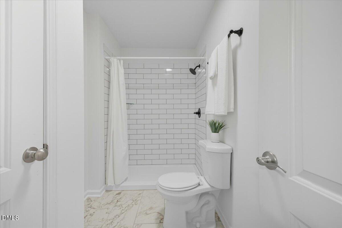 102 Choptank Court, Unit A2 Cary, NC 27513 - Photo 14 of 24 a bathroom with a toilet and shower