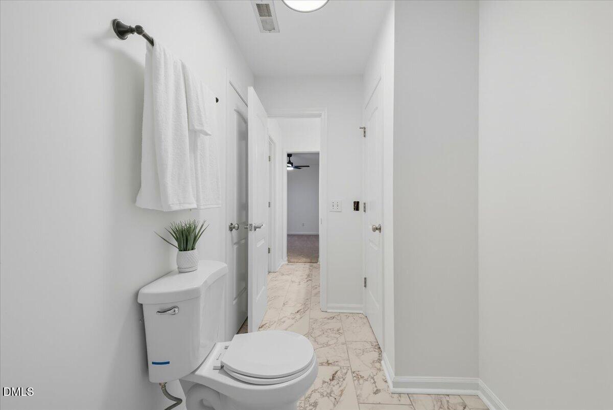 102 Choptank Court, Unit A2 Cary, NC 27513 - Photo 15 of 24 a white toilet sitting next to a bathroom sink