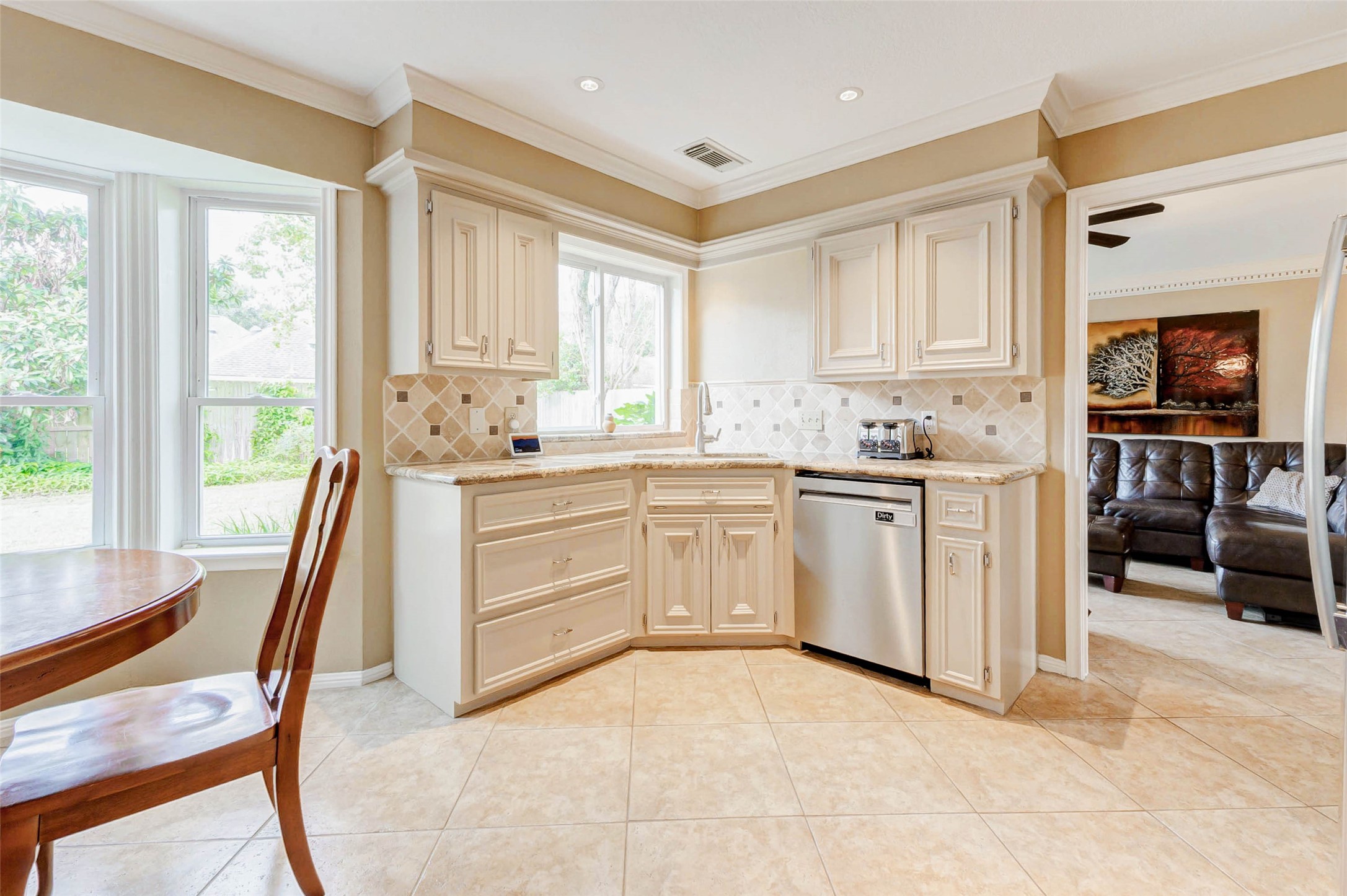 15811 Spring Forest Drive Houston, TX 77059 - Photo 9 of 27 Discover the perfect blend of elegance and functionality in this kitchen, featuring stunning granite countertops that complement the bright, airy design.
