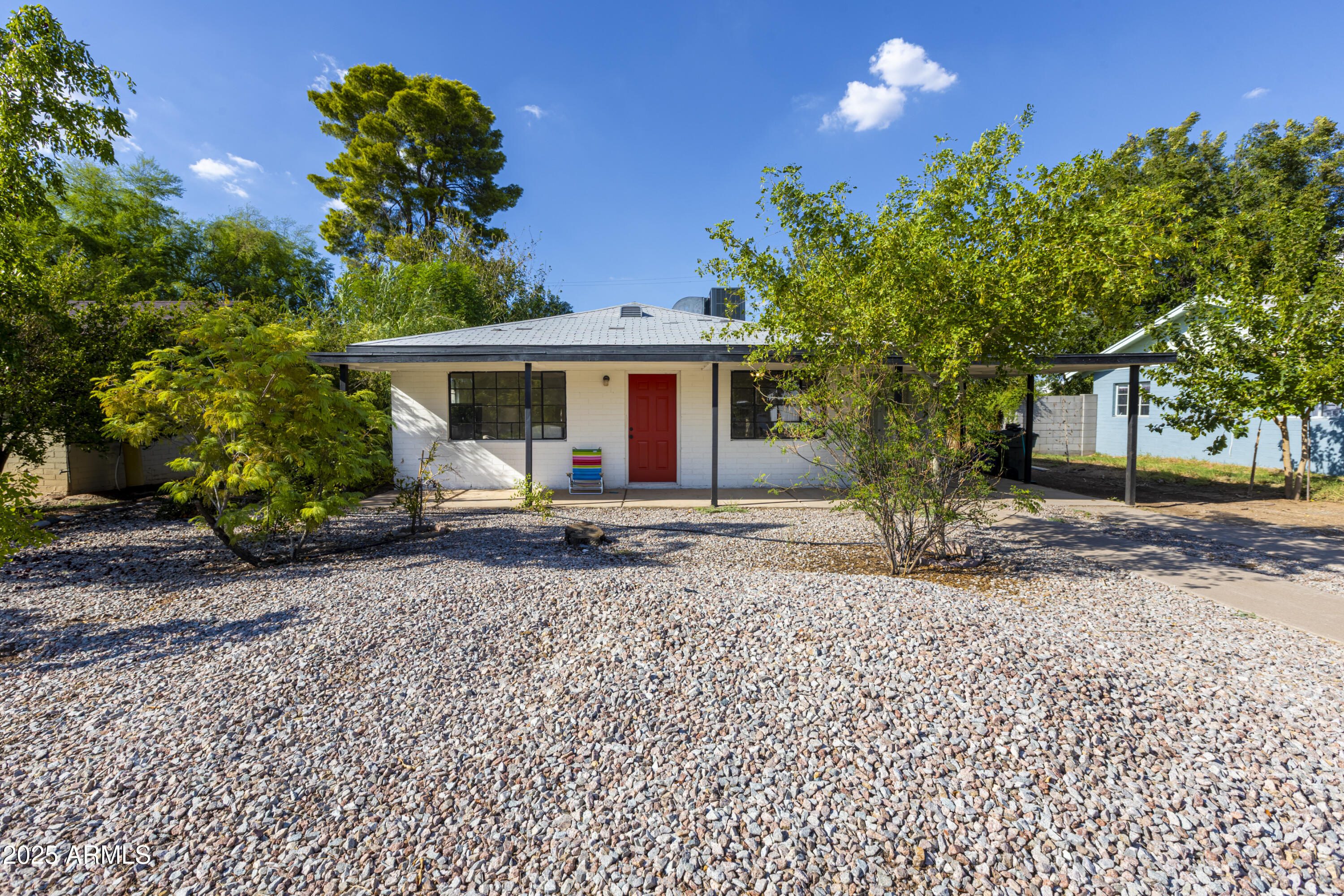 a view of a house with a tree and a yard