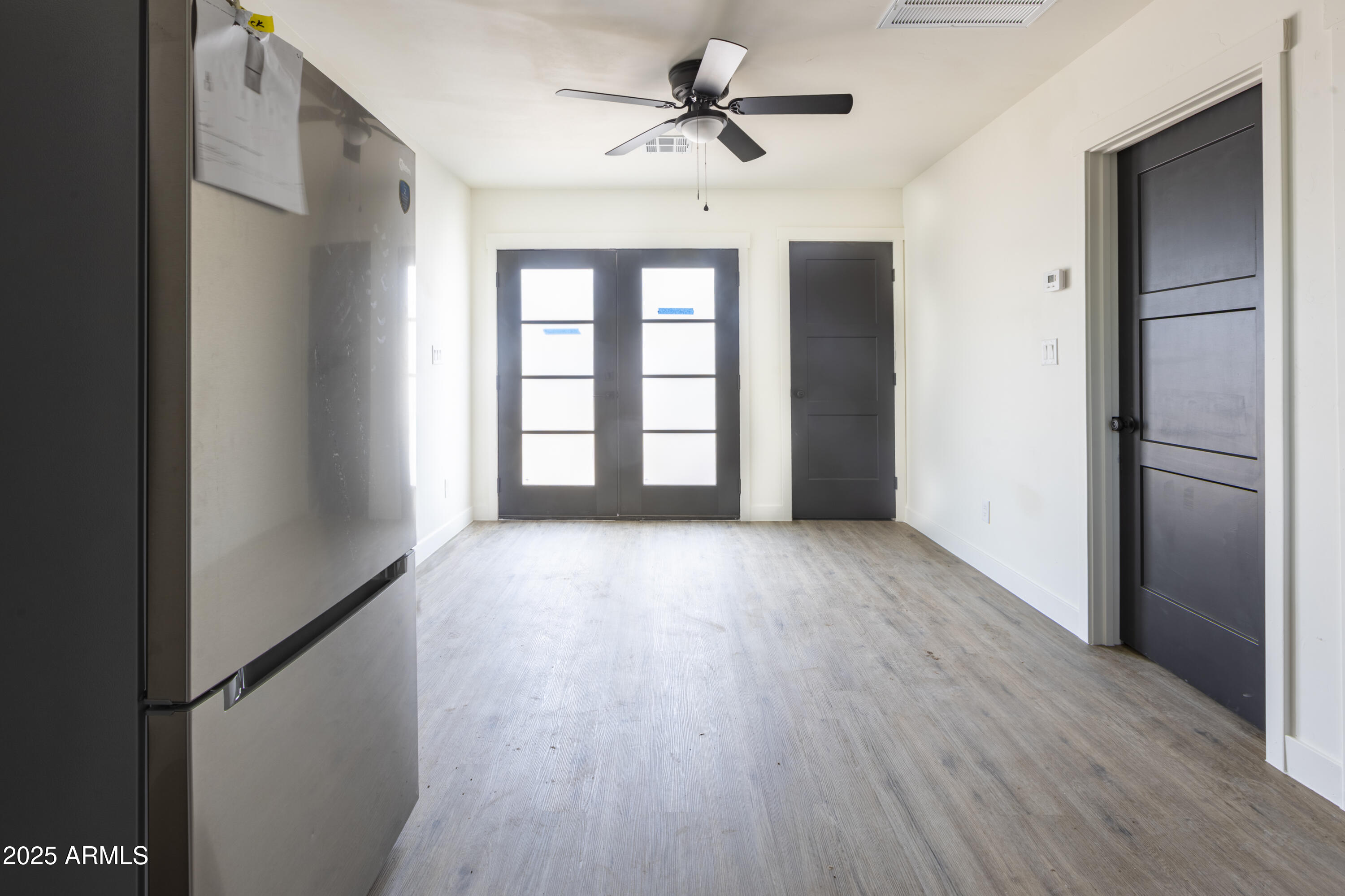 1324 East Hall Street Tempe, AZ 85281 - Photo 15 of 25 a view of an empty room with a window and wooden floor