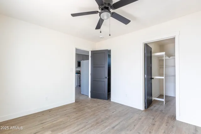 a view of an empty room with wooden floor