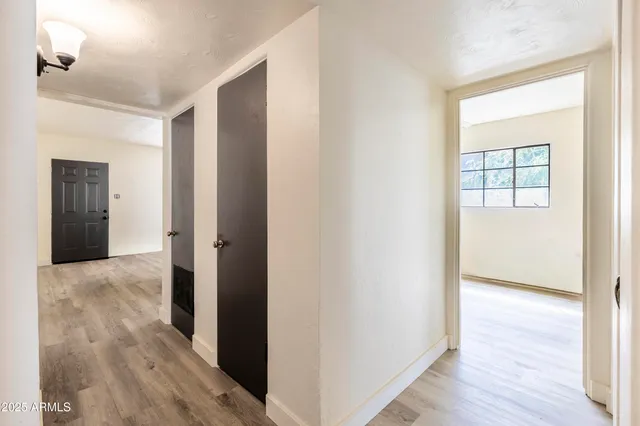 a view of hallway with wooden floor